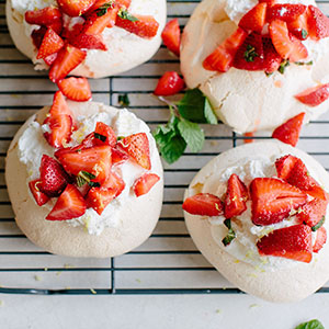 mini pavlovas with whipped cream and strawberries